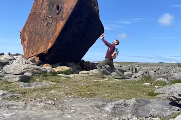 man pushing rock